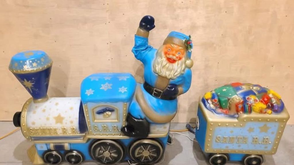 Light blue painted Santa Claus on train blow mold, vintage.